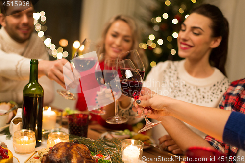 Image of close up of friends with wine celebrate christmas