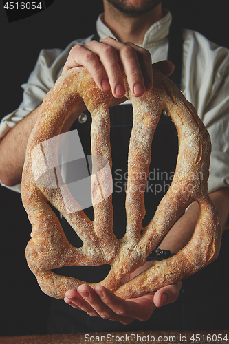 Image of Baker holding fougas bread