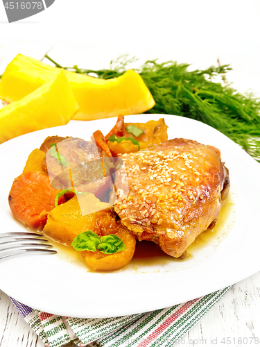 Image of Chicken roast with pumpkin and dried apricots on table