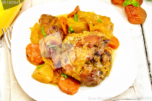 Image of Chicken roast with pumpkin and carrots on wooden board