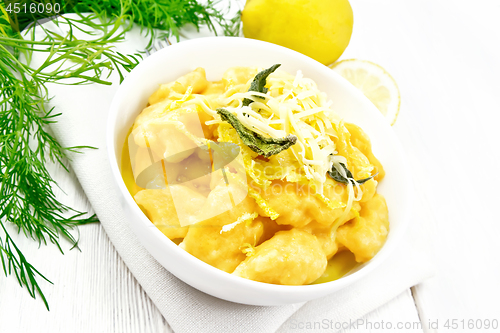 Image of Gnocchi pumpkin with lemon in bowl on light board