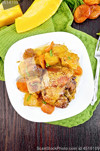 Image of Chicken roast with pumpkin and dried apricots on dark board top