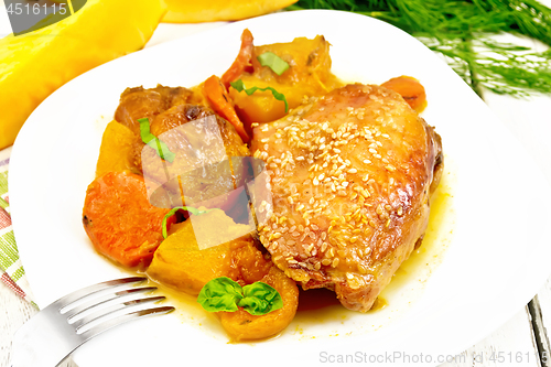 Image of Chicken roast with pumpkin and dried apricots on light board