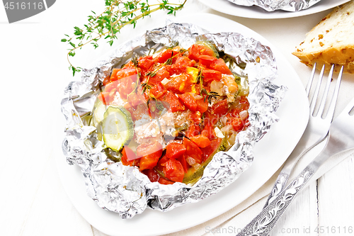 Image of Salmon with vegetables in plate on board