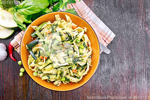 Image of Tagliatelle with green vegetables on board top