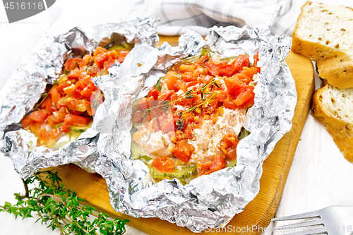 Image of Salmon with vegetables in foil on light board
