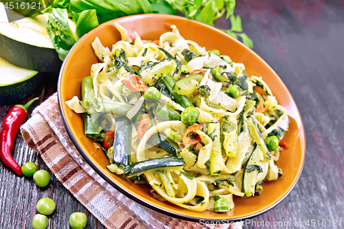 Image of Tagliatelle with green vegetables on board