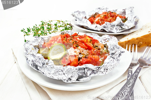 Image of Salmon with vegetables in plate on light board