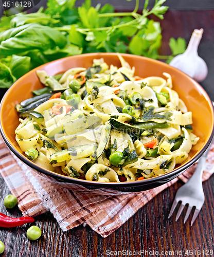 Image of Tagliatelle with green vegetables on towel