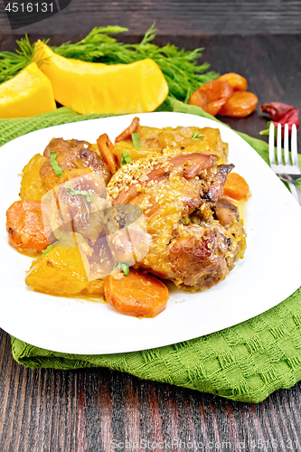 Image of Chicken roast with pumpkin and dried apricots on green towel