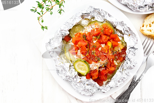 Image of Salmon with vegetables in plate on board top