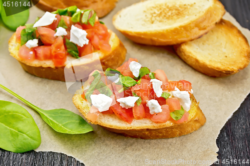 Image of Bruschetta with tomato and cheese on table