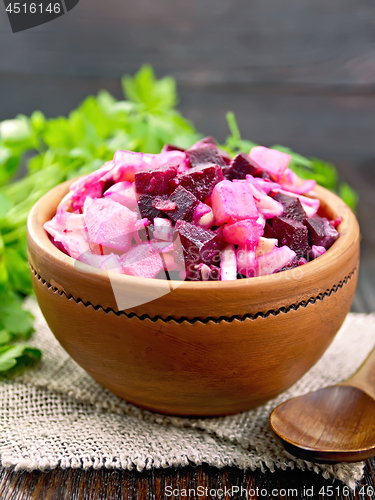 Image of Vinaigrette in clay bowl on board