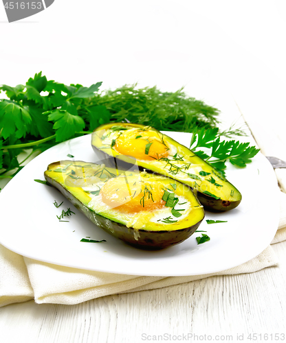 Image of Scrambled eggs in avocado on light board