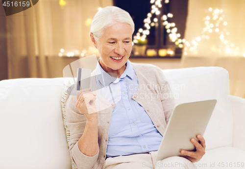 Image of senior woman with tablet computer and credit card