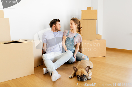 Image of happy couple with boxes and dog moving to new home