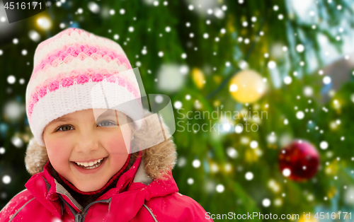 Image of happy little girl in winter clothes outdoors