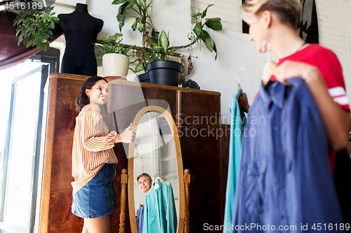 Image of women choosing clothes at vintage clothing store