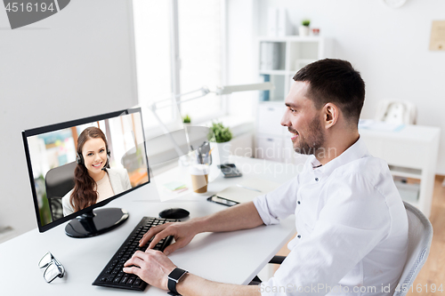 Image of businessman having video call on pc at office