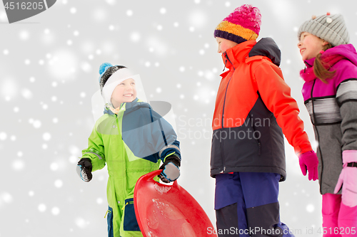 Image of happy little kids with sleds in winter