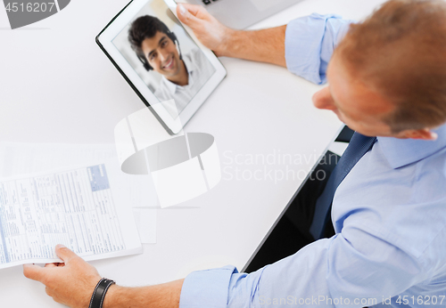 Image of businessman having video call on tablet pc
