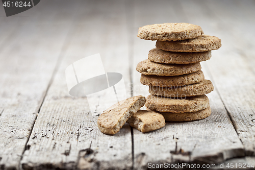 Image of Stack of fresh baked oat cookies on rustic wooden table backgrou