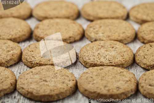 Image of Fresh baked oat cookies closeup on rustic wooden table.