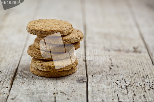 Image of Stack of fresh baked oat cookies on rustic wooden table backgrou