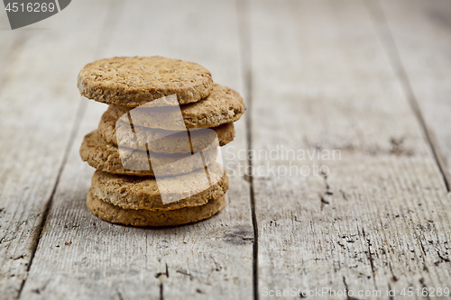 Image of Stack of fresh baked oat cookies on rustic wooden table backgrou