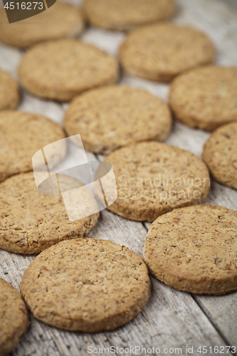 Image of Fresh baked oat cookies closeup on rustic wooden table backgroun