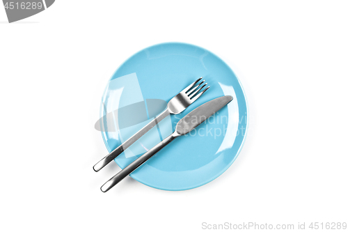 Image of Set of empty blue plate, fork and knife on white background.