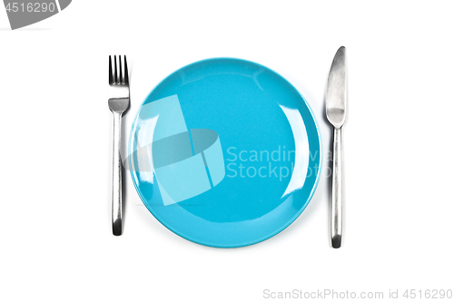 Image of Set of empty blue plate, fork and knife on white background.