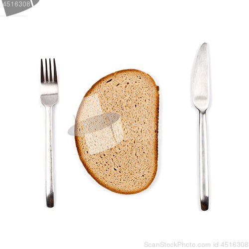 Image of Fresh baked bread slice, fork and knife on white background. 