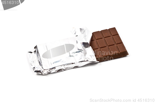 Image of Milk chocolate bar in foil isolated on white.