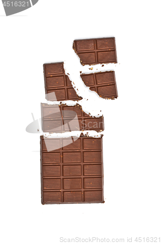 Image of Broken milk chocolate bar wit hazelnuts.