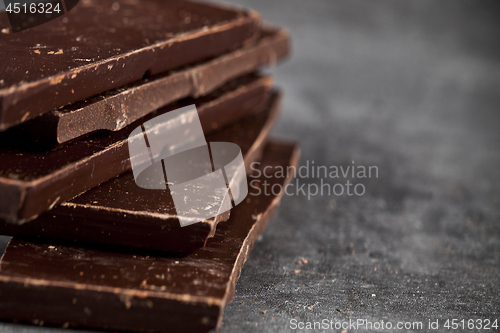 Image of Dark chocolate bar pieces closeup. Sweet food photo concept. 