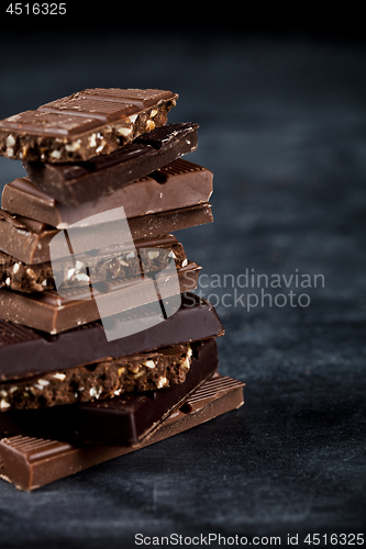 Image of Chocolate bar pieces closeup. Sweet food photo concept.