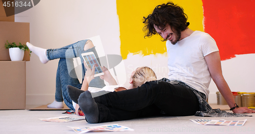 Image of Happy young couple relaxing after painting
