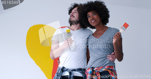 Image of couple with painted heart on wall