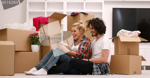 Image of young couple moving  in new house