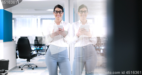 Image of Business Woman Using Digital Tablet in front of Office