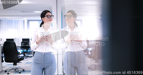 Image of Business Woman Using Digital Tablet in front of Office