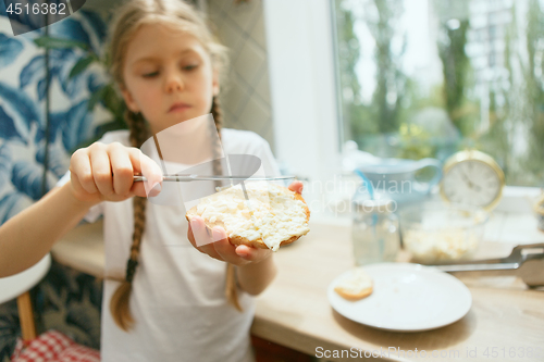 Image of Beautiful girl in her kitchen in the morning preparing breakfast