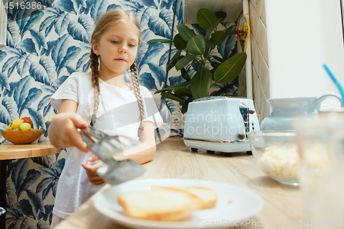 Image of Beautiful girl in her kitchen in the morning preparing breakfast