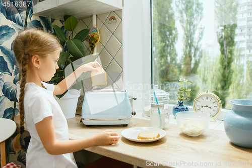 Image of Beautiful girl in her kitchen in the morning preparing breakfast