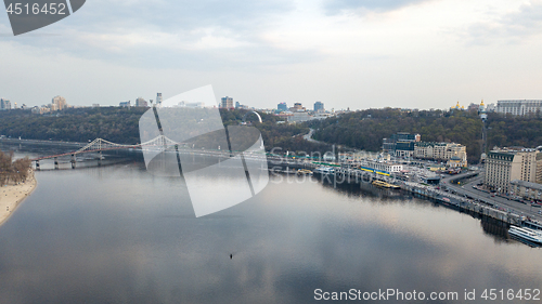 Image of The panoramic bird\'s eye view shooting from drone of the Podol district, the right bank of the Dnieper River and centre of Kiev, Ukraine summer evening at sunset on the background of the cloudy sky.