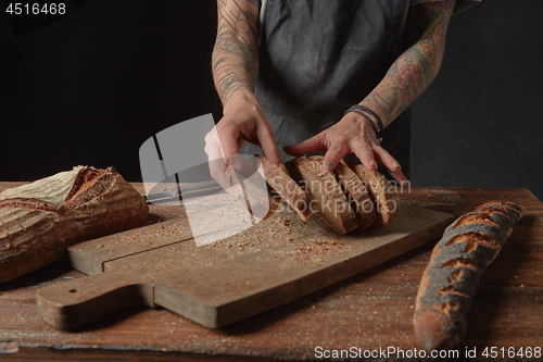 Image of Baker Holds Bran Bread