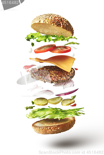 Image of Delicious hamburger with flying ingredients