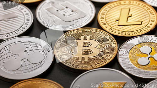 Image of Close-up of shiny gold and silver coins on a dark background. Business and technology concept. Top view