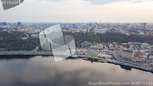 Image of The panoramic bird\'s eye view shooting from drone of the Podol district, the right bank of the Dnieper River and centre of Kiev, Ukraine at summer sunset on the background of the cloudy sky.